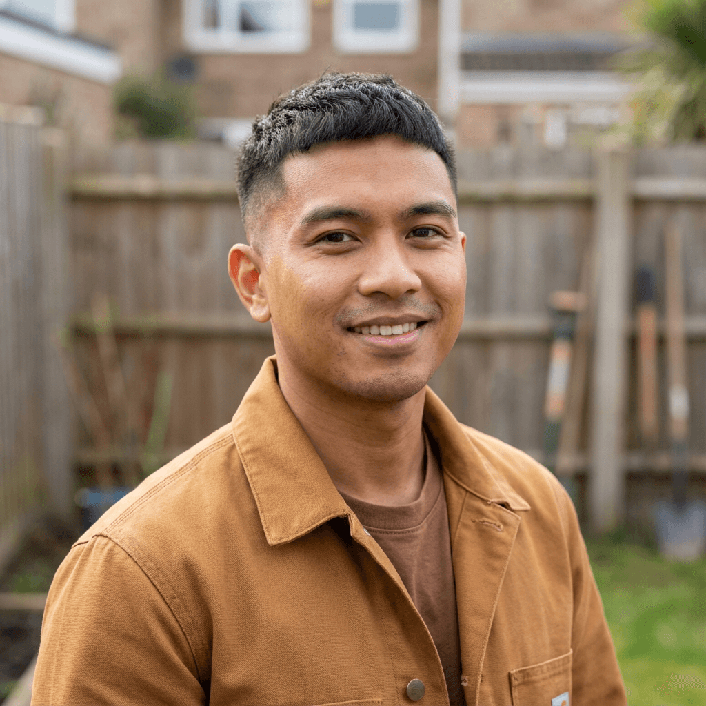 Marcus Chen smiling outdoors by the coast